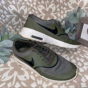 Olive green Nike shoes.
